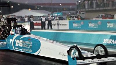 The top fuel dragster, driven by US driver Tommy Johnson takes on fellow American “Hot” Rod Fuller, right, during the Yas Drag Racing Festival.