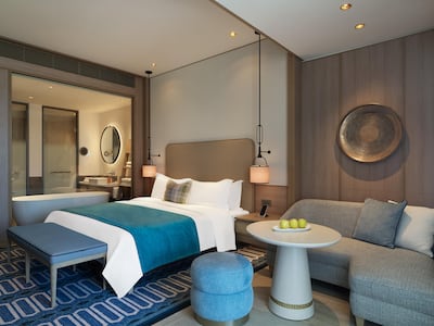 A glass wall separates the stand-alone bath from the rest of the room. Photo: City of Dreams Mediterranean