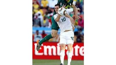 Algeria's Rafik Saifi, below, and Slovenia's Bostjan Cesar battle for a header at the Peter Mokaba stadium in Polokwane.