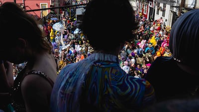 Mardi Gras revellers look out over the St Anne Parade on February 21 in New Orleans, Louisiana. Getty / AFP