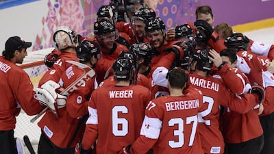 Canada's players celebrate after winning the men's ice hockey final against Sweden at the Bolshoy Ice Dome during the Sochi Winter Olympics on February 23, 2014. Alexander Nemenov / AFP