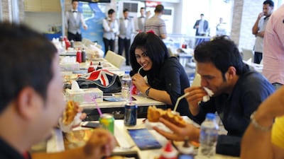 Young Iraqis enjoy lunch at a fast-food restaurant in eastern Baghdad. Reuters
