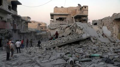The Syrian Civil Defence White Helmets and residents search for victims under the rubble of destroyed buildings that was hit by airstrikes in the northern town of Maaret Al Numan, in Idlib province, Syria. Russia has announced a ceasefire in Syria's rebel-held Idlib province from Saturday morning. AP