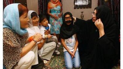 Sherifa Madgwick, right, of the Sharjah Centre for Cultural Communication, conducts a cultural session for tourists. Satish Kumar / The National