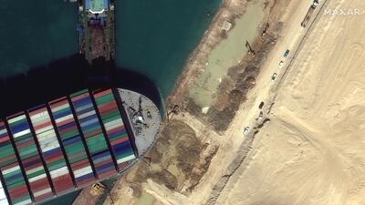 A view of the earth moving equipment excavating sand near the bow of the Ever Given container ship in Suez Canal in this Maxar Technologies satellite image. Reuters