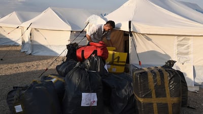 A migrant arrives at a refugee camp in Nea Kavala, northern Greece. About 1,500 asylum-seekers transported from Greece's eastern Aegean island of Lesbos to the mainland. Around 1,000 of those transferred and housed in Nea Kavala, where they will be staying in tents until the end of the month, after which they will be transferred to a new camp under construction. AP