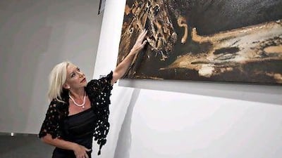 The artist Marie-Josée Primeau stands in front of her exhibition at the Abu Dhabi Art Fair. Andrew Henderson / The National