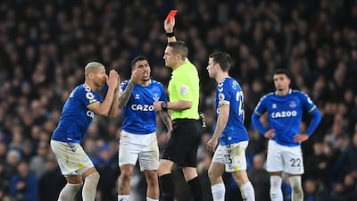 Referee Craig Pawson shows Allan a red card. Getty