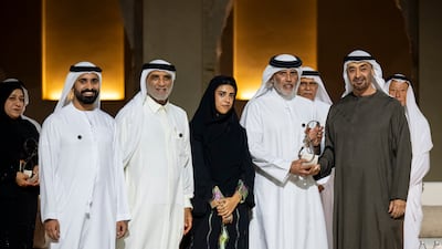 President Sheikh Mohamed with Abu Dhabi Award winner Abdelmonem bin Eisa Alserkal and his family, during a ceremony at Qasr Al Hosn. Photo: UAE Presidential Court