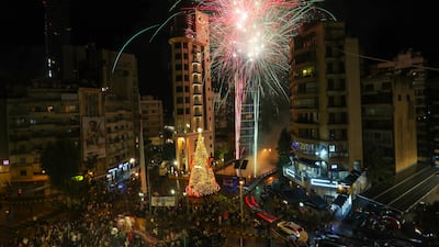 People watch fireworks above a Christmas tree, which has been officially lit up at the Ashrafieh area in Beirut, Lebanon. EPA