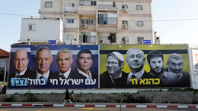 An election billboard for the centrist Israeli Blue and White alliance alongside a panel for the Likud party. Abir Sultan / EPA