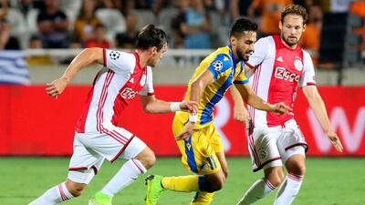 APOEL midfielder Musa Suliman takes on the Ajax defence. EPA