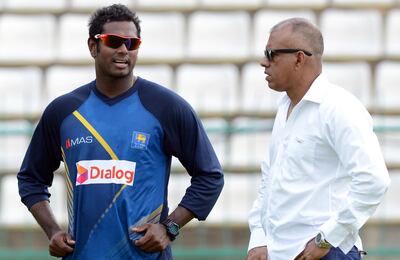 Sri Lanka team manager Charith Senanayake, right, seen here in 2016 with Sri Lanka cricketer Angelo Mathews. AFP