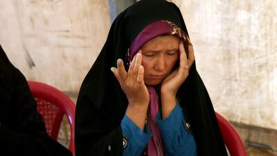 Afghan deportee, Tajigul Haidary, 26, right, is at the Afghanistan-Iranian border point, on the outskirts of Islam Qala in Herat province in Afghanistan hoping to return to Iran where her husband and children are. Haidary had overstayed her residents' visa in Iran and was expecting just a hefty fine but was instead deported as an illegal immigrant. Massoud Hossaini/AP Photo
