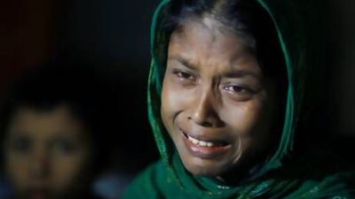 A Rohingya Muslim woman whose husband was allegedly killed in Myanmar, cries as she waits with others to be sent back to Myanmar at a camp of Border Guards of Bangladesh or BGB, in Taknaf, Bangladesh, Friday, June 22, 2012. Bangladesh turned back more than 2,000 Rohingyas who tried to enter the country after the deadly violence between Rohingyas and ethnic Rakhine Buddhists erupted this month. (AP Photo/Saurabh Das)