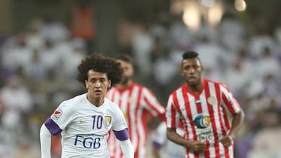 Omar Abdulrahman of Al Ain, left, speeds past Al Jazira defenders during their win on Sunday night at Hazza bin Zayed Stadium. Anas Kanni / Al Ittihad
