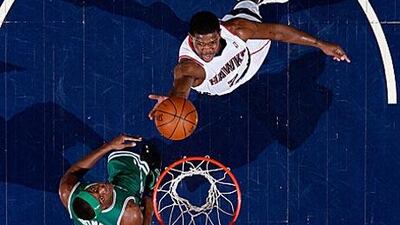 Joe Johnson of the Atlanta Hawks lays in a basket against Rajon Rondo of the Boston Celtics.