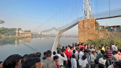 People gather as rescuers search for survivors after the suspension bridge collapse in Morbi, western Gujarat state. Reuters