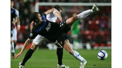 Jonny Evans of Manchester United battles with Rickie Lambert of Southampton during United's FA Cup fourth-round triumph at the St Mary's Stadium yesterday.