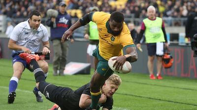 New Zealand's Damian McKenzie (L) tackles Australia's Filipo Daugunu as he scores a try during the Bledisloe Cup rugby union match between New Zealand and Australia in Wellington. AFP