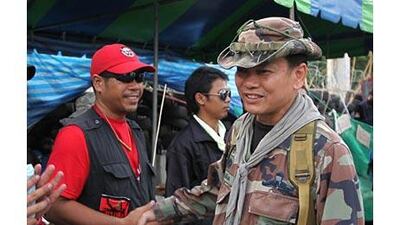 Major Gen Khattiya Sawasdipol, right, at the anti-government protesters' rally in Bangkok.