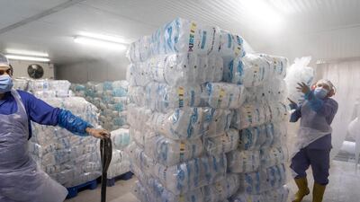 Tube ice packed in 1 kilogram, 2kg, 5kg and 20kg are refrigerated at -18°C in preparation for delivery to retail outlets through the UAE. With a production capacity that runs for 24 hours a day, the factory can produce 120 tonnes of ice using 250,000 litres of water. Antonie Robertson / The National