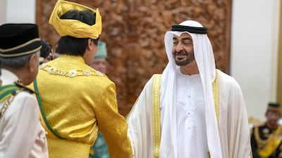 KUALA LUMPUR, MALAYSIA - July 30, 2019: HH Sheikh Mohamed bin Zayed Al Nahyan, Crown Prince of Abu Dhabi and Deputy Supreme Commander of the UAE Armed Forces (R) greets a guest during the inauguration of HM King Abdullah Ri’ayatuddin Al-Mustafa Billah Shah of Malaysia (not shown), at Istana Negara, the National Palace of Malaysia. ( Rashed Al Mansoori / Ministry of Presidential Affairs ) ---