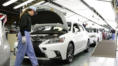 Workers check Lexus vehicles on the Miyawaka assembly line. Toyota's luxury brand Lexus will start selling its new NX compact SUV in the United States from November and aims to sell 42,000 of the SUVs annually. Toru Yamanaka / AFP