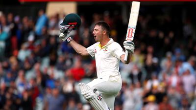 Shaun Marsh raises his bat in celebration after reaching his century against England on Day 2 in Adelaide. David Gray / Reuters
