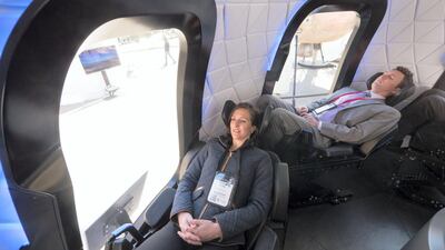 Attendees sit inside the high fidelity crew capsule mock up of the Blue Origin LLC New Shepard system during the Space Symposium in Colorado Springs, Colorado, U.S. Bloomberg