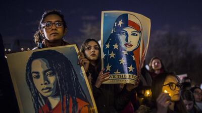 Protesters hold signs during a rally against President Donald Trump's order cracking down on immigrants living in the US at Washington Square Park in New York last week. Andres Kudacki / AP Photo