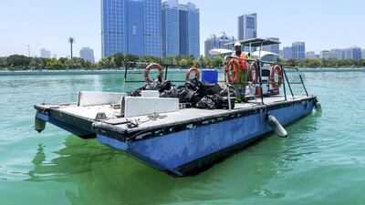 Dive volunteers with the collected bags of trash at Abu Dhabi Dhow Harbour. Victor Besa / The National