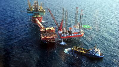 Oil platforms at Abu Dhabi’s offshore Nasr Field. The emirate's growth weakened this year due to its compliance to a global oil production cut. Wam