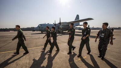 Japanese Disaster Relief Team members walk to a P3-C aircraft before its departure for Australia at Subang Air base in Subang, Selangor, Malaysia. Ahmad Yusni / EPA