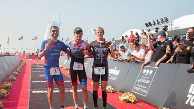 Left to right, Adam Bowden (third), Bart Aernouts (first), and Pieter Heemeryck (second) were the best three in the men's section of Ironman Dubai at Jumeirah beach. Leslie Pableo for The National