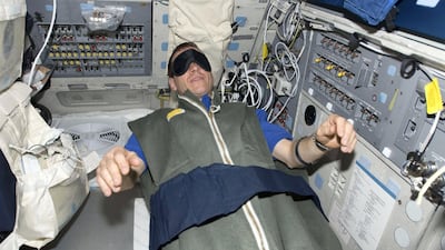 Astronaut Gregory C. Johnson, STS-125 pilot, rests in his sleeping bag on the flight deck of the Earth-orbiting space shuttle Atlantis in May 2009. Nasa / Reuters