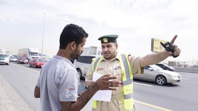 First Lieutenant, Essa Ahmed helps a man, who stopped to ask for directions. Reem Mohammed / The National