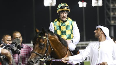 Jockey Richard Hughes rode Rabbah De Carrere, trained by Majed Al Jahouri, right, and owned by Sheikh Mansour bin Zayed, to victory at the Mazrat Al Ruwayah at Meydan Racecourse. Razan Alzayani / The National