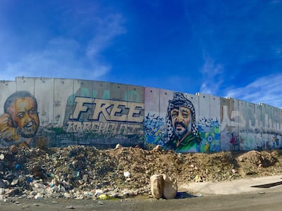 Images of Palestinian activist Marwan Barghouti, left, and former PLO president Yasser Arafat on a Palestinian-Israeli separation fence between Jerusalem and Ramallah. Photo: Reel Palestine
