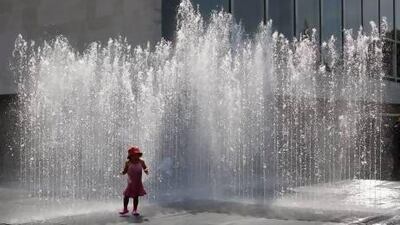 Londoners cool off wherever they can. Oli Scarff / Getty Images