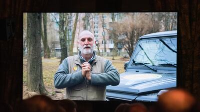Jose Andres is seen on a screen giving a pre-recorded acceptance speech for receiving The Sophia Award for Excellence 2022 from Ukraine, while he works there to feed those affected by the war on March 31, 2022. EPA