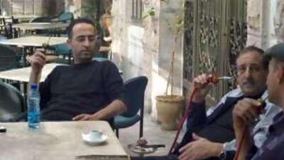 Firaz Yassin, left, manager of the Diwan coffee shop, says the US election is of little interest to people in Ramallah.