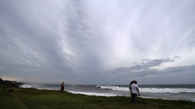 People watch the high waves in Sainte-Anne. AFP