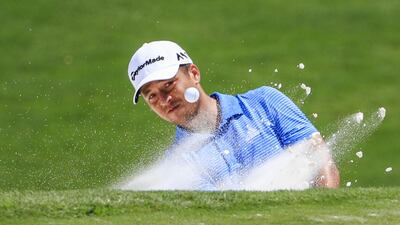 Xander Schauffele of the US hits from a sand trap by the eighteenth green. Tannen Maury / EPA