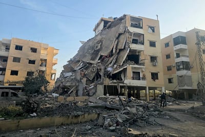 Residents gather at the site of an Israeli airstrike that targeted a neighbourhood in Tyre. AFP