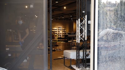 A worker stands inside a damaged store at Forum des Halles in Paris. AFP
