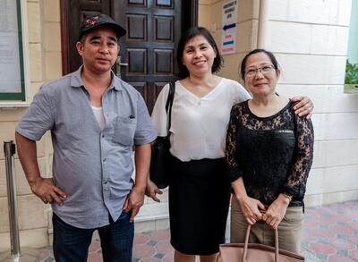 Reynaldo Delos Reyes, Merybeth Kuizon and Lida Detros, 45 cast their vote on the day polls opened in Abu Dhabi. Victor Besa/The National