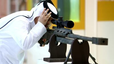 An Adihex visitor inspects a machine gun. Warren Little / Getty Images