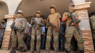 Fighters from the Libyan Government of National Accord (GNA) stand guard on June 20, 2021, in the town of Buwairat Al Hassoun. AFP