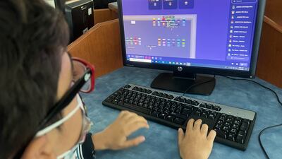 A pupil in the UAE uses a computer during the Games for Change Game Exchange. Photo: Games for Change